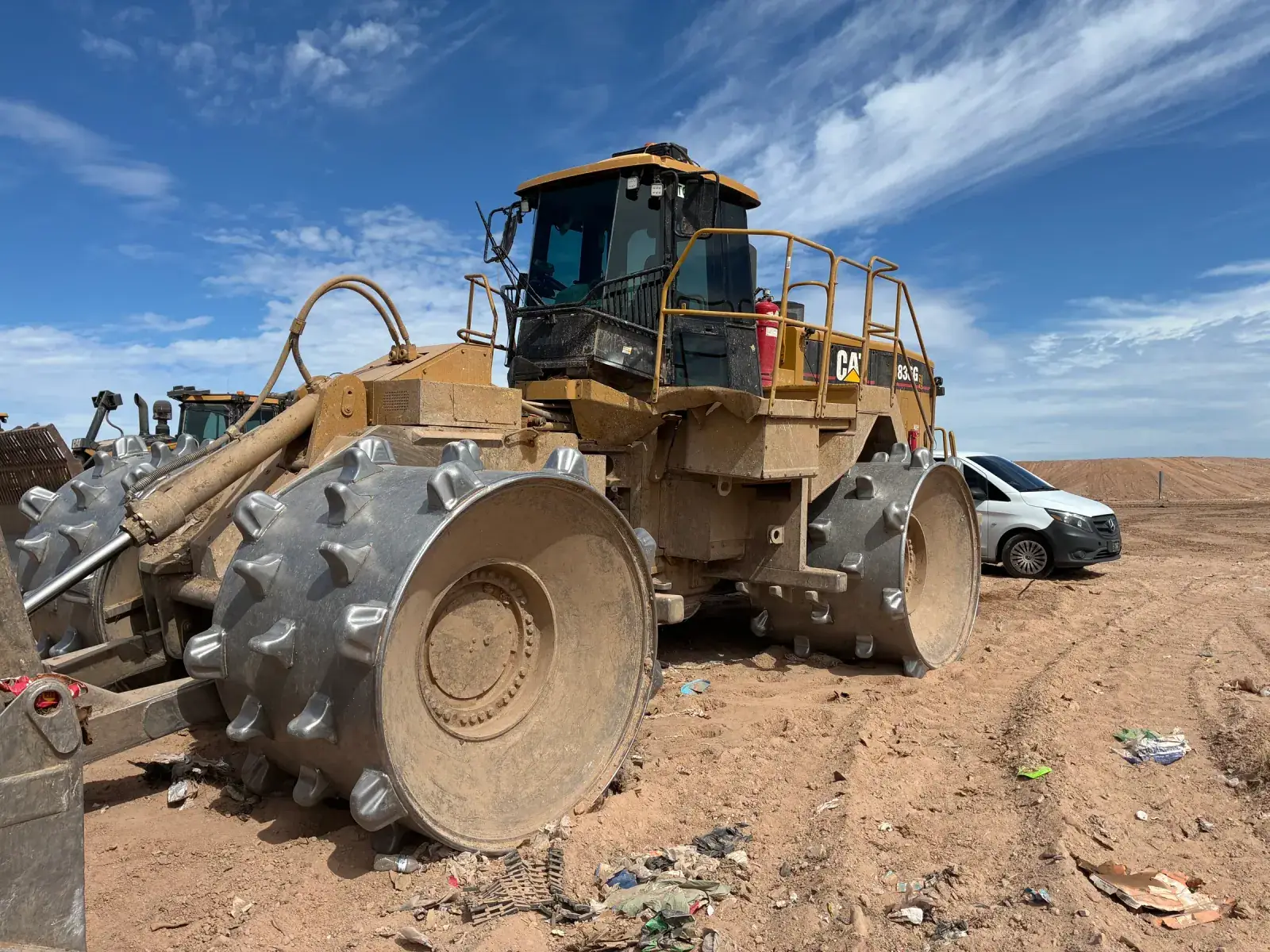 Large yellow wheel loader with dark-tinted cab windows at a work site